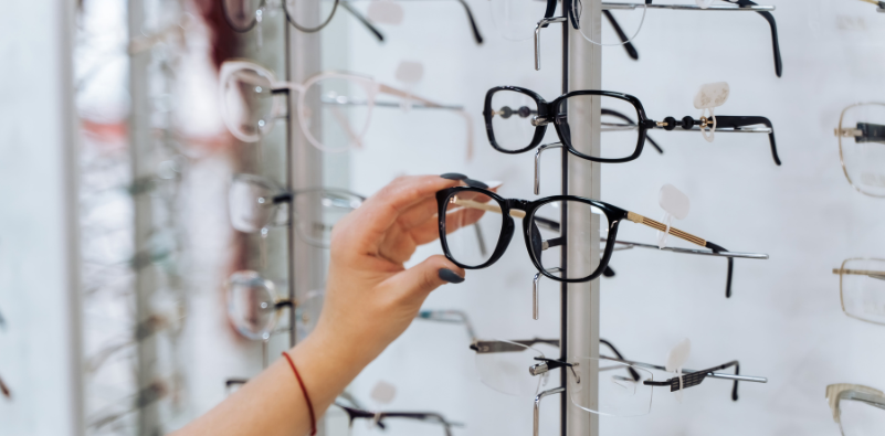 Client in optics choosing glasses
